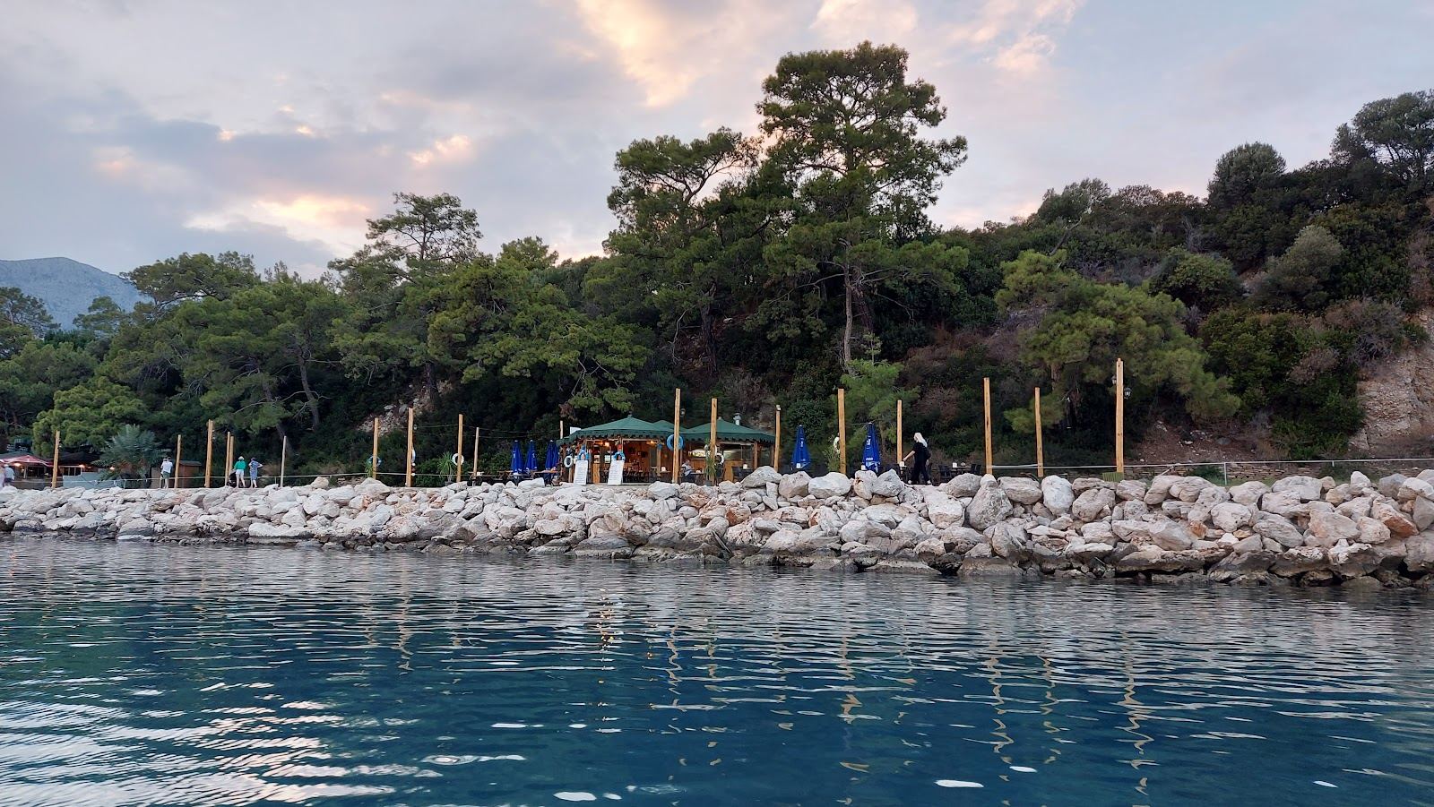 The crescent Moonlight bay at Kemer with calm clear water and the Taurus mountains behind near Antalya