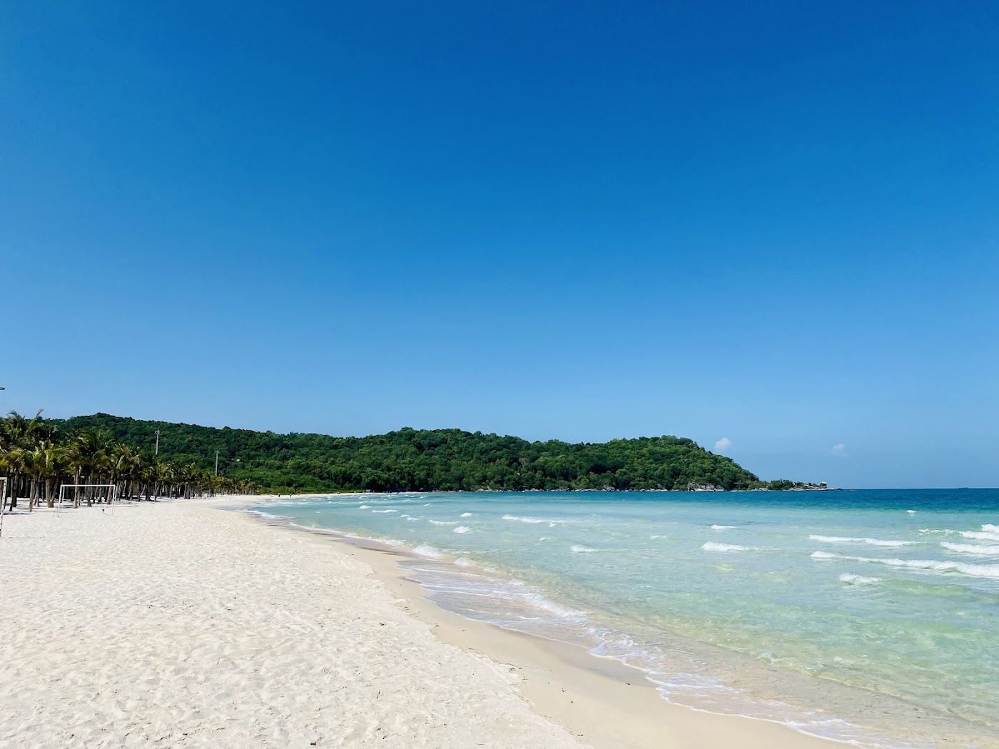 Softly curving bay of fine white sand and calm clear water at Bai Khem beach near An Thoi in southern Phu Quoc