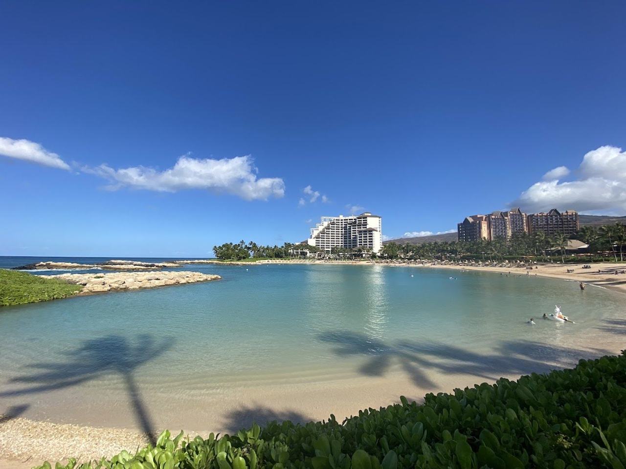 Calm man made Ko Olina lagoon fringed by palms on the leeward coast of Oahu