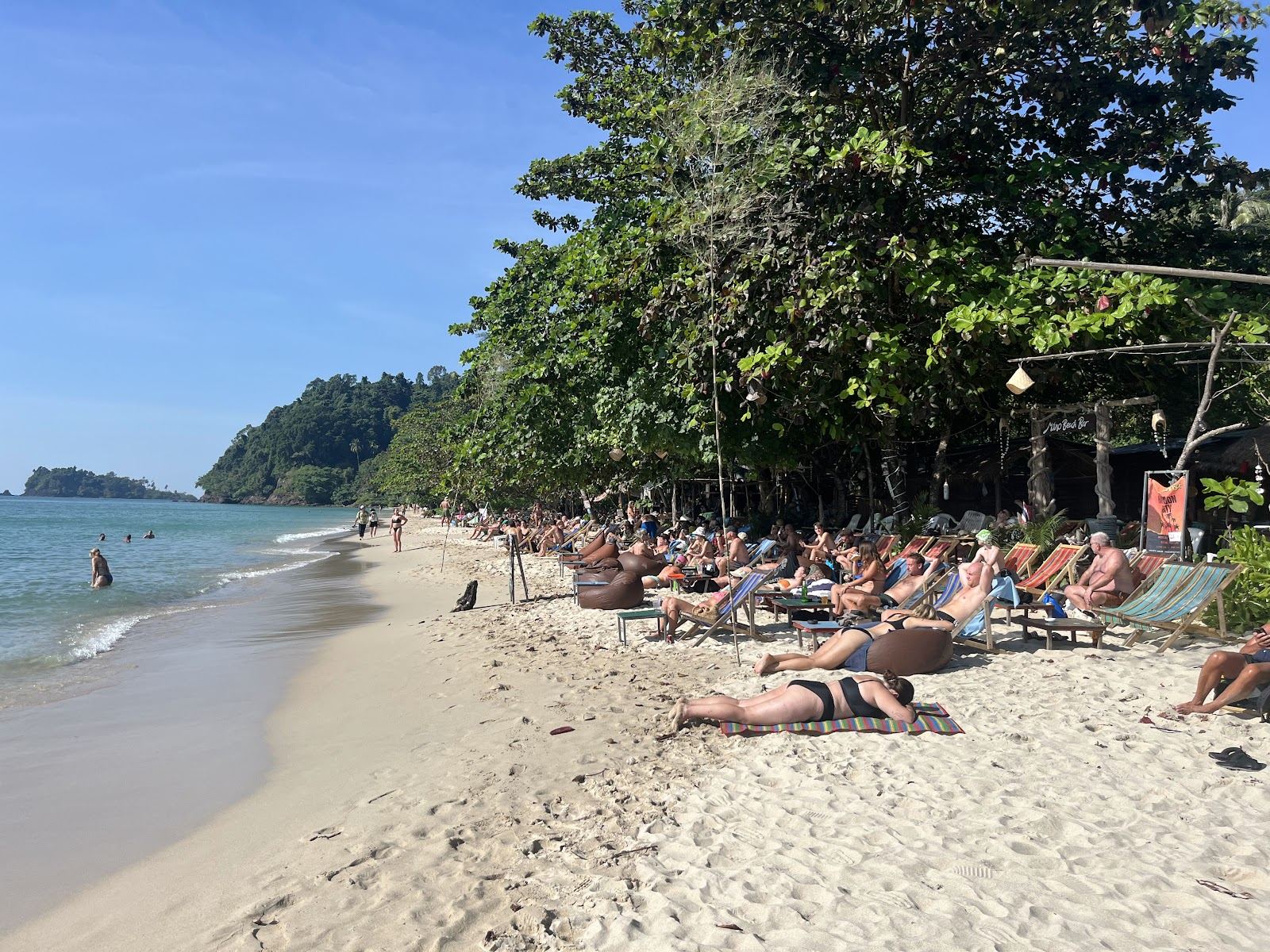 Relaxed sandy bay with bars behind it at Lonely Beach on Koh Chang