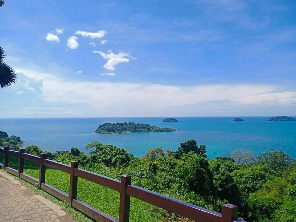 Calm clear sea and a green mountainous shore on Koh Chang in Thailand