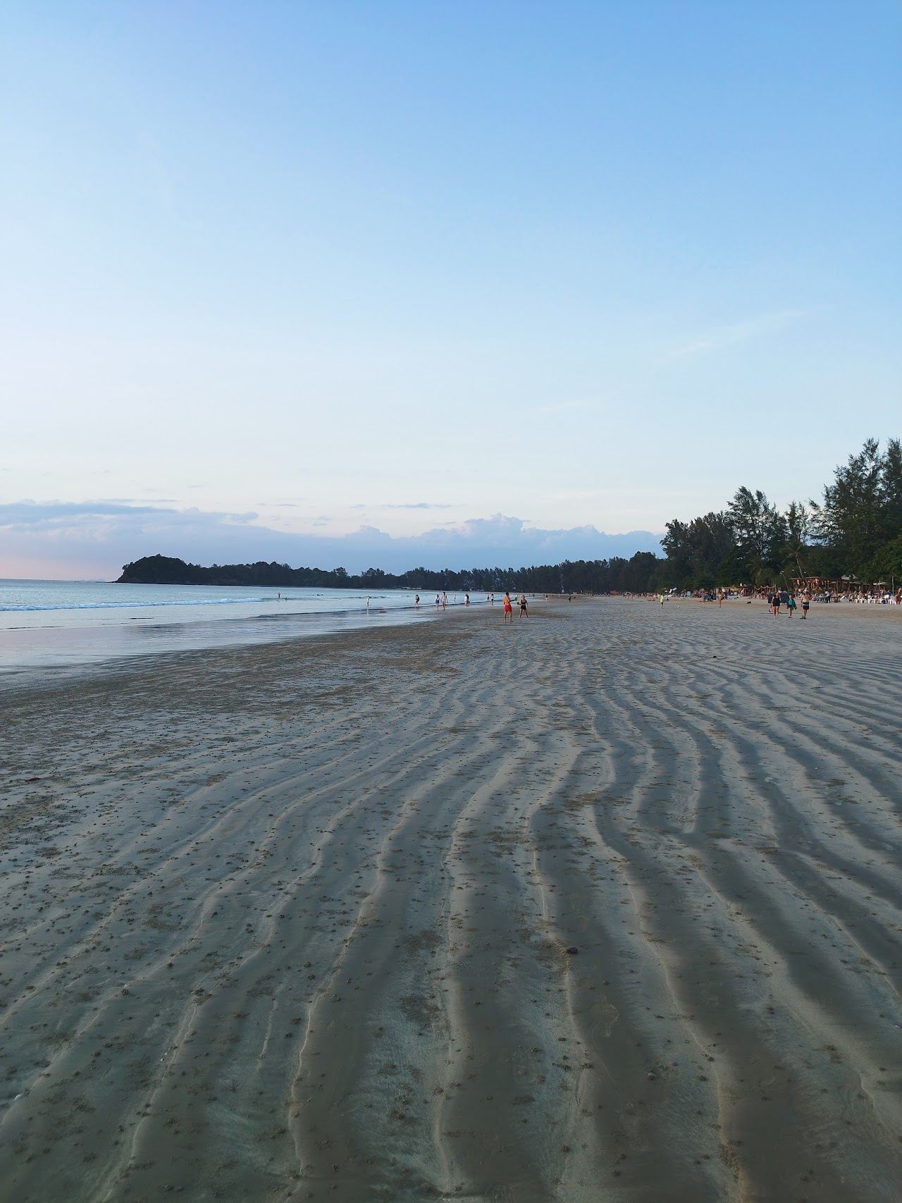 Golden sunset light over the calm water at Klong Dao Beach on Koh Lanta