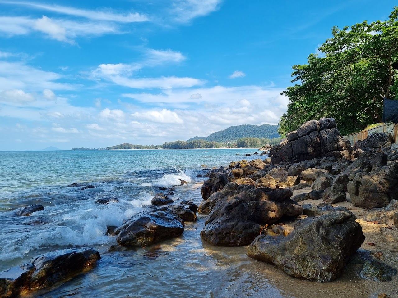 Small sheltered cove between green headlands at Relax Bay on Koh Lanta