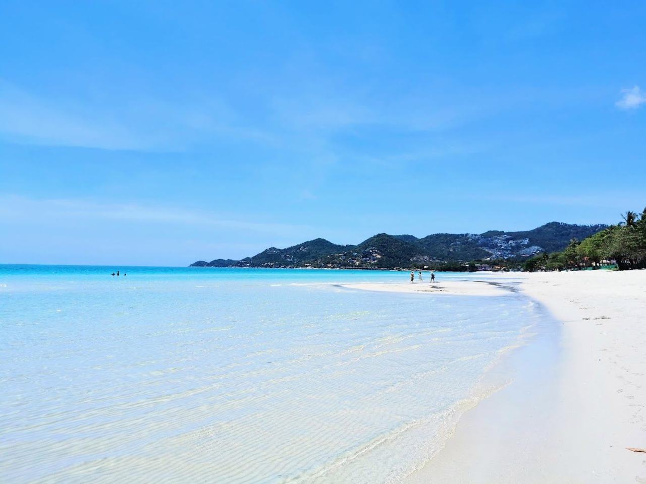 Long sweep of sand and calm Gulf water along Chaweng beach on Koh Samui