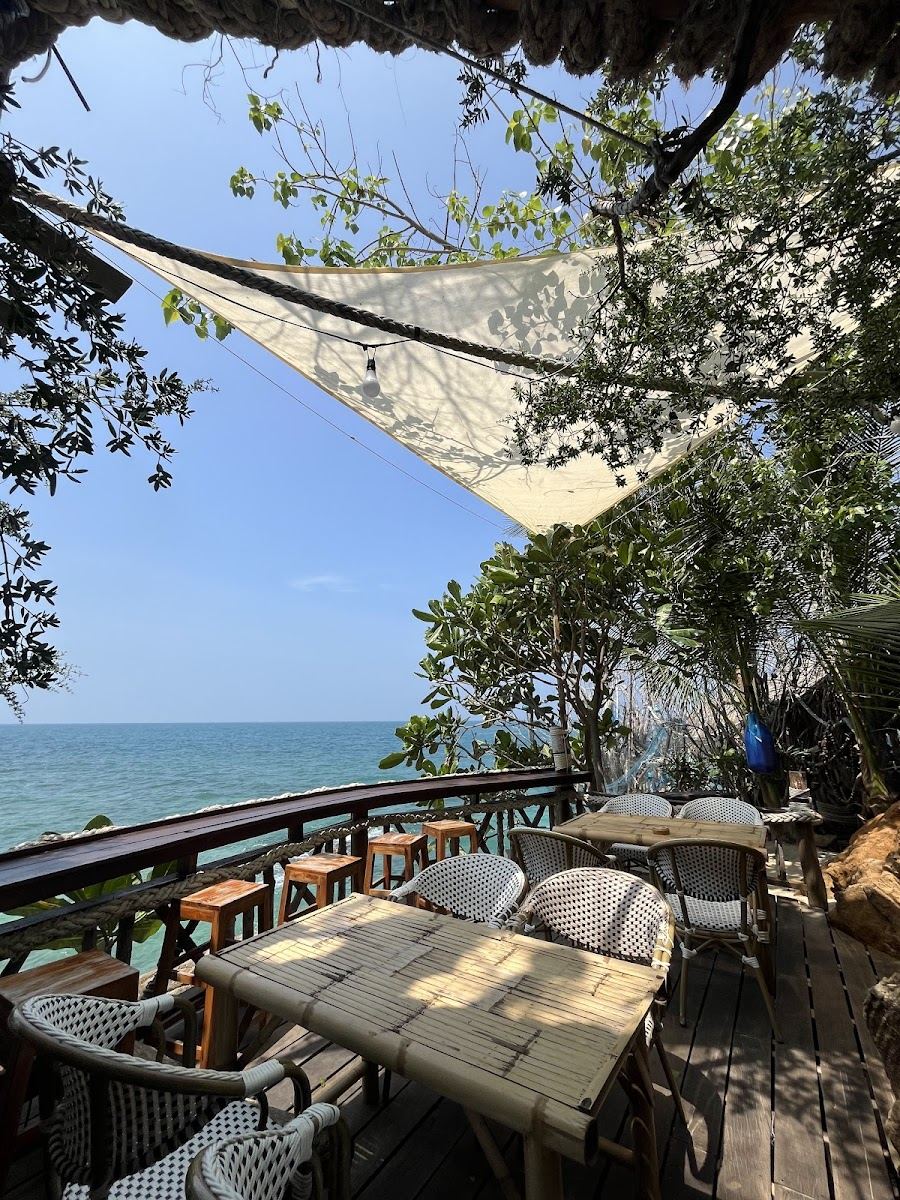 Wooden pirate ship bar on the rocks at sunset at Pirates Bar in Koh Phangan