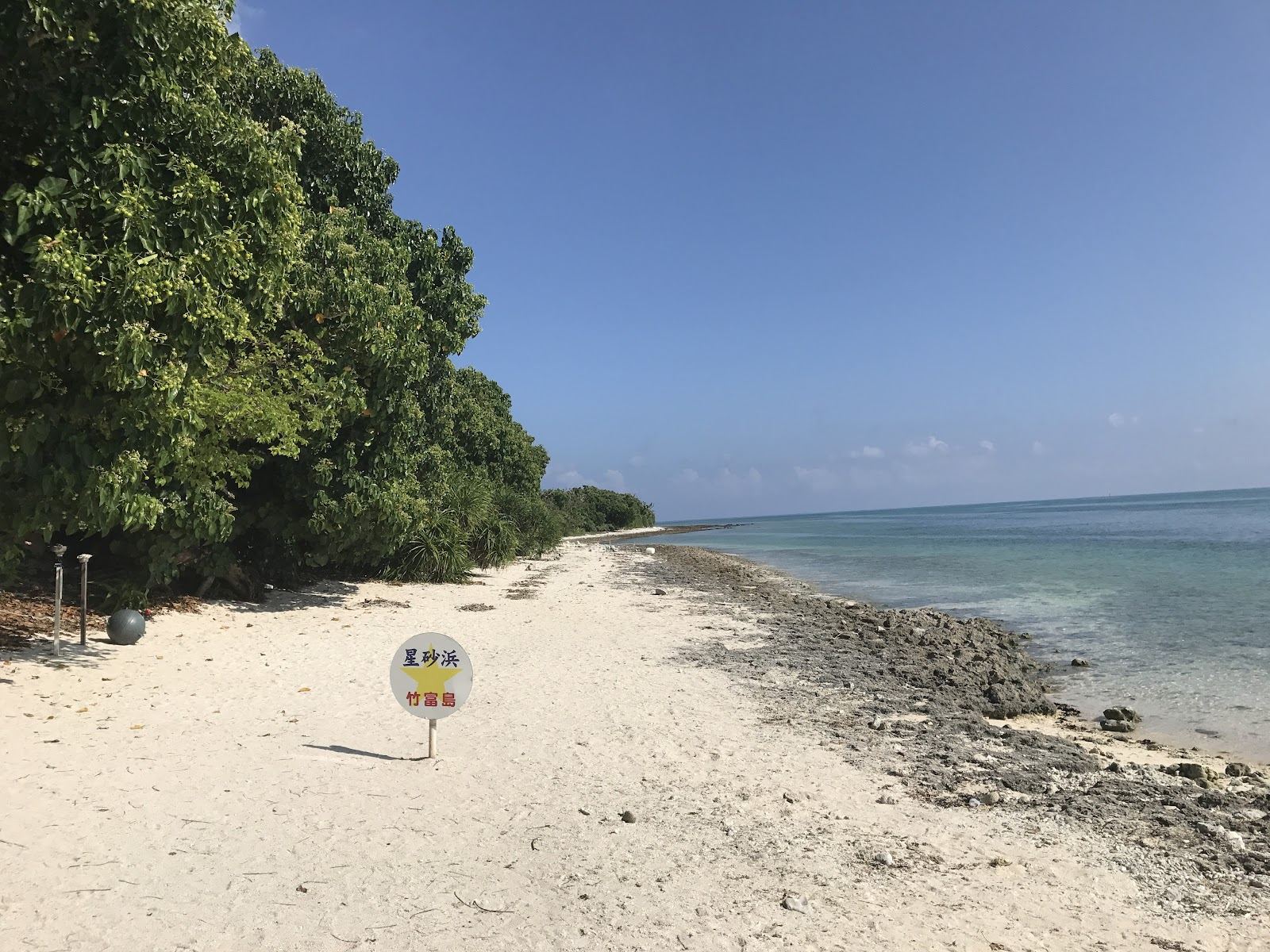 The pale sand and clear shallows near Kaiji Beach on Taketomi in the Yaeyama islands of Okinawa