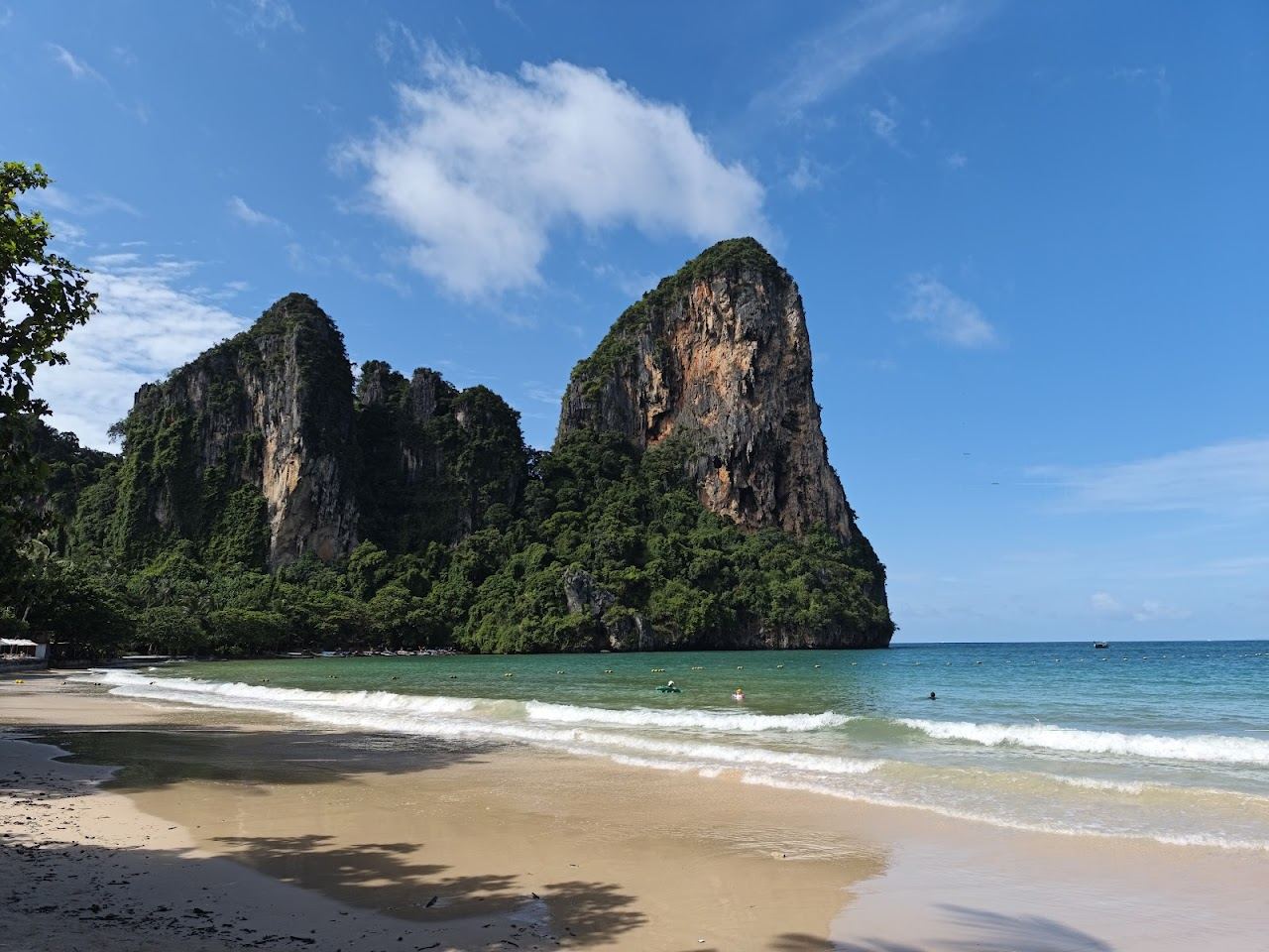 Limestone cliffs and calm evening water at Railay West beach in Krabi