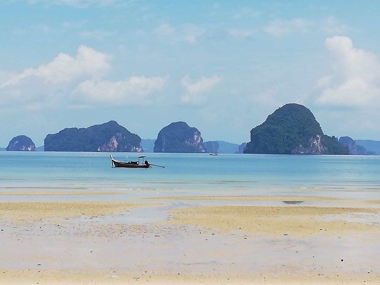 Quiet sand and island silhouettes at sunset on Tubkaak beach in Krabi
