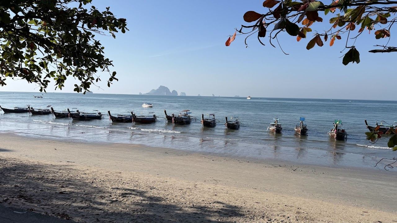 Longtail boats on the calm water at Ao Nang beach, the watersports launch point in Krabi