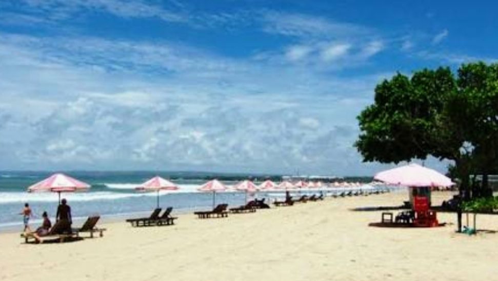 The long shoreline of Kuta Beach in Bali from above