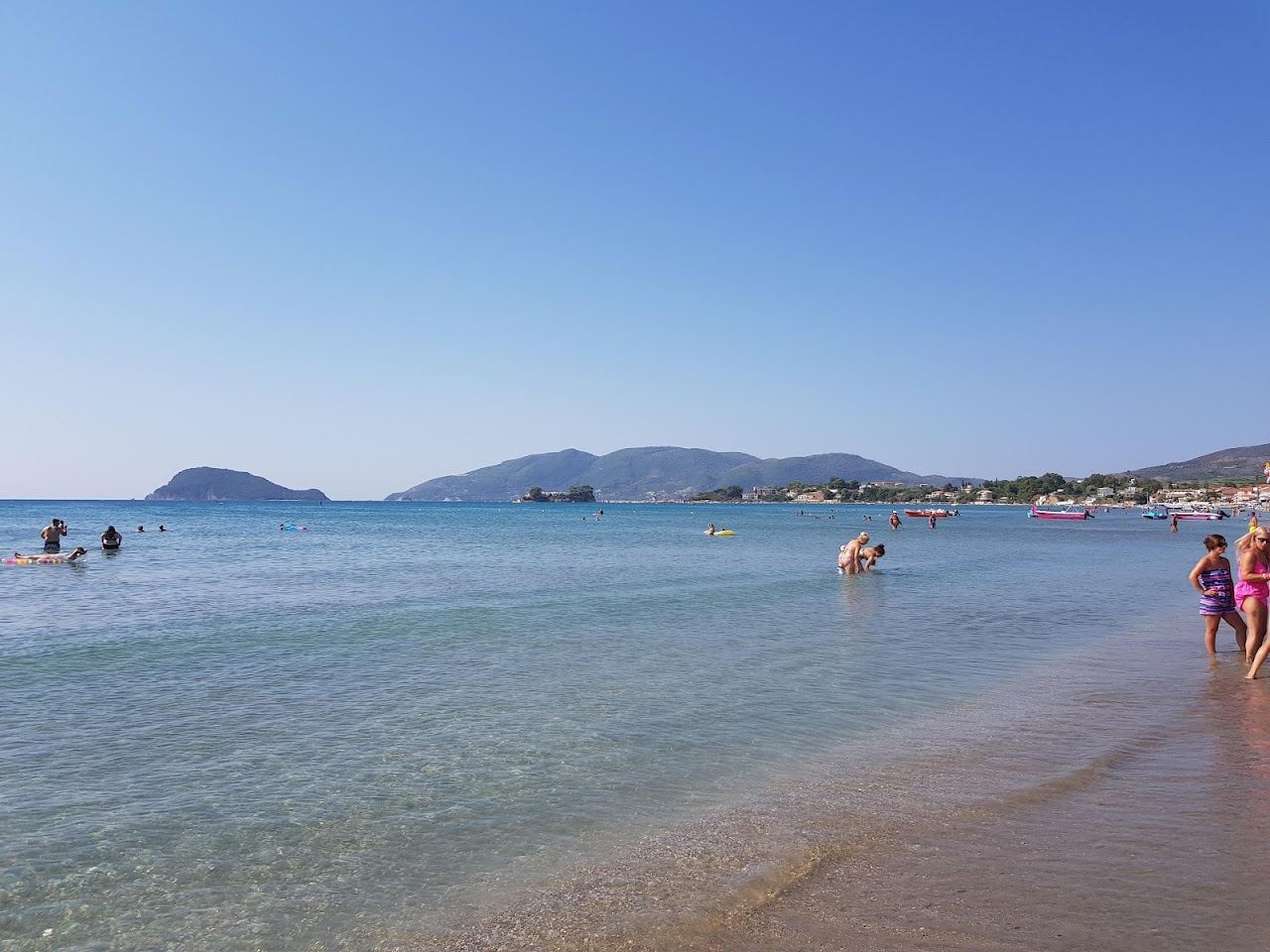 Calm shallow water and wide soft sand along Laganas beach in the protected bay of Zakynthos