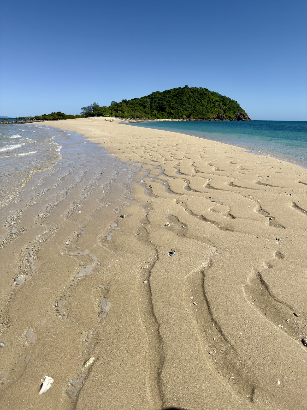 Sand spit and clear reef water off Langford Island near Hayman in the Whitsundays
