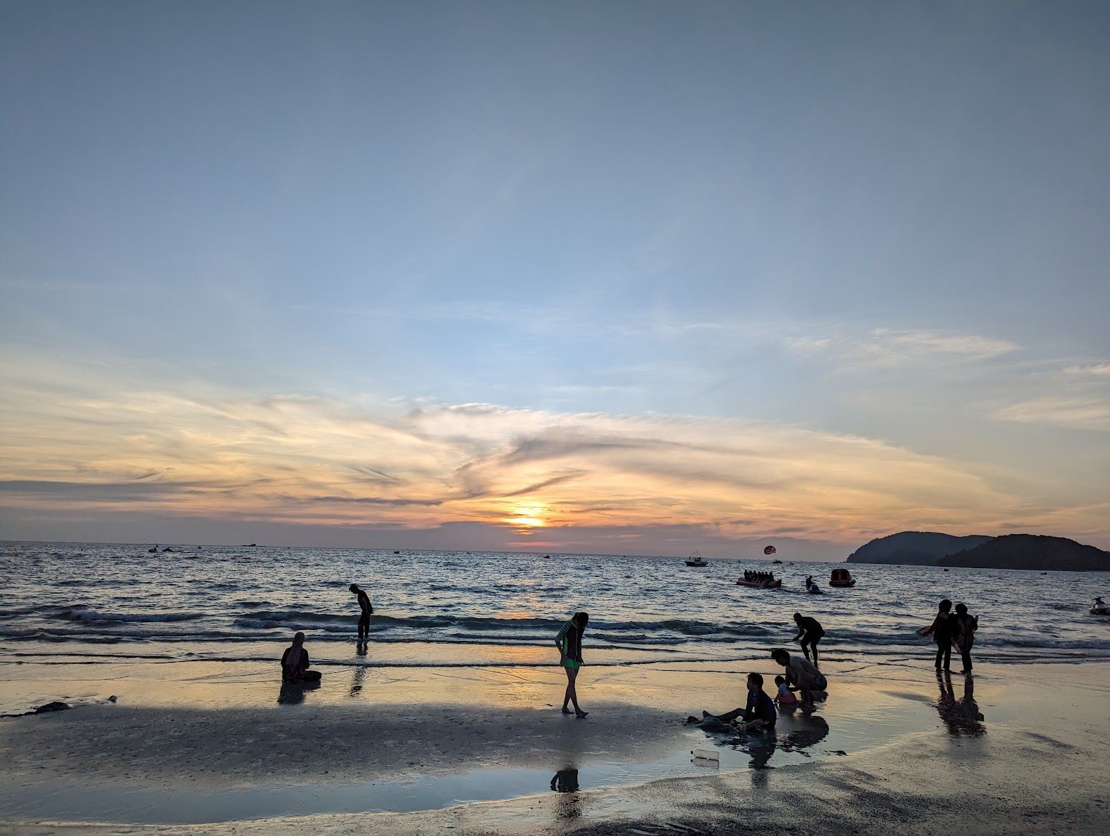 Golden light over the Andaman Sea from the west facing sand of Pantai Cenang in Langkawi