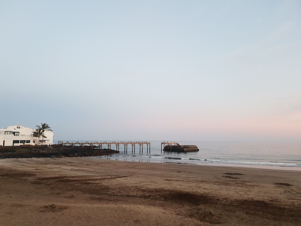 Calm sheltered family bay with golden sand and gentle water in Lanzarote