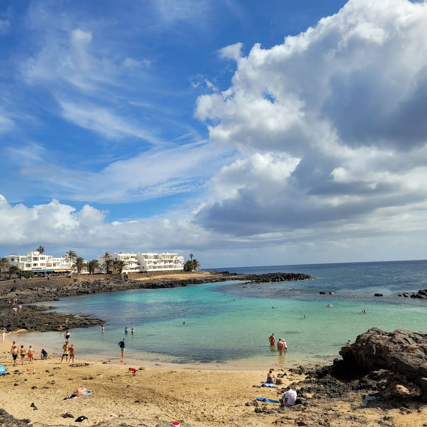 Clear Atlantic water over volcanic rock at a sheltered Lanzarote cove