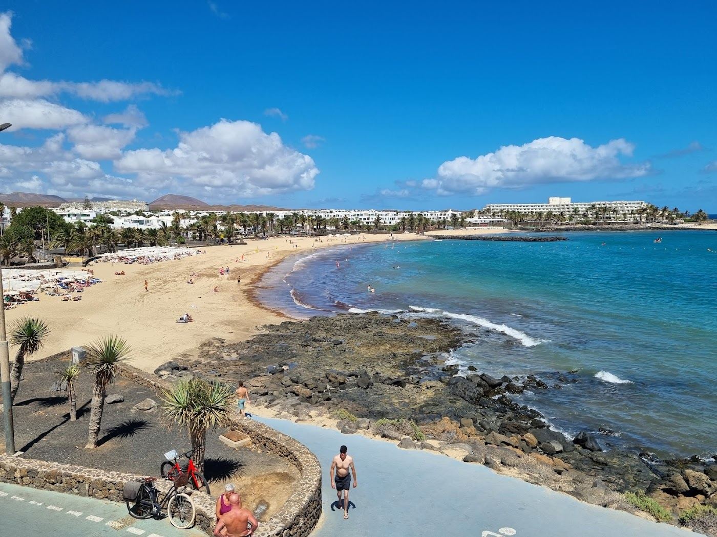 Broad golden windsurf beach with sails and breeze at Las Cucharas in Costa Teguise, Lanzarote