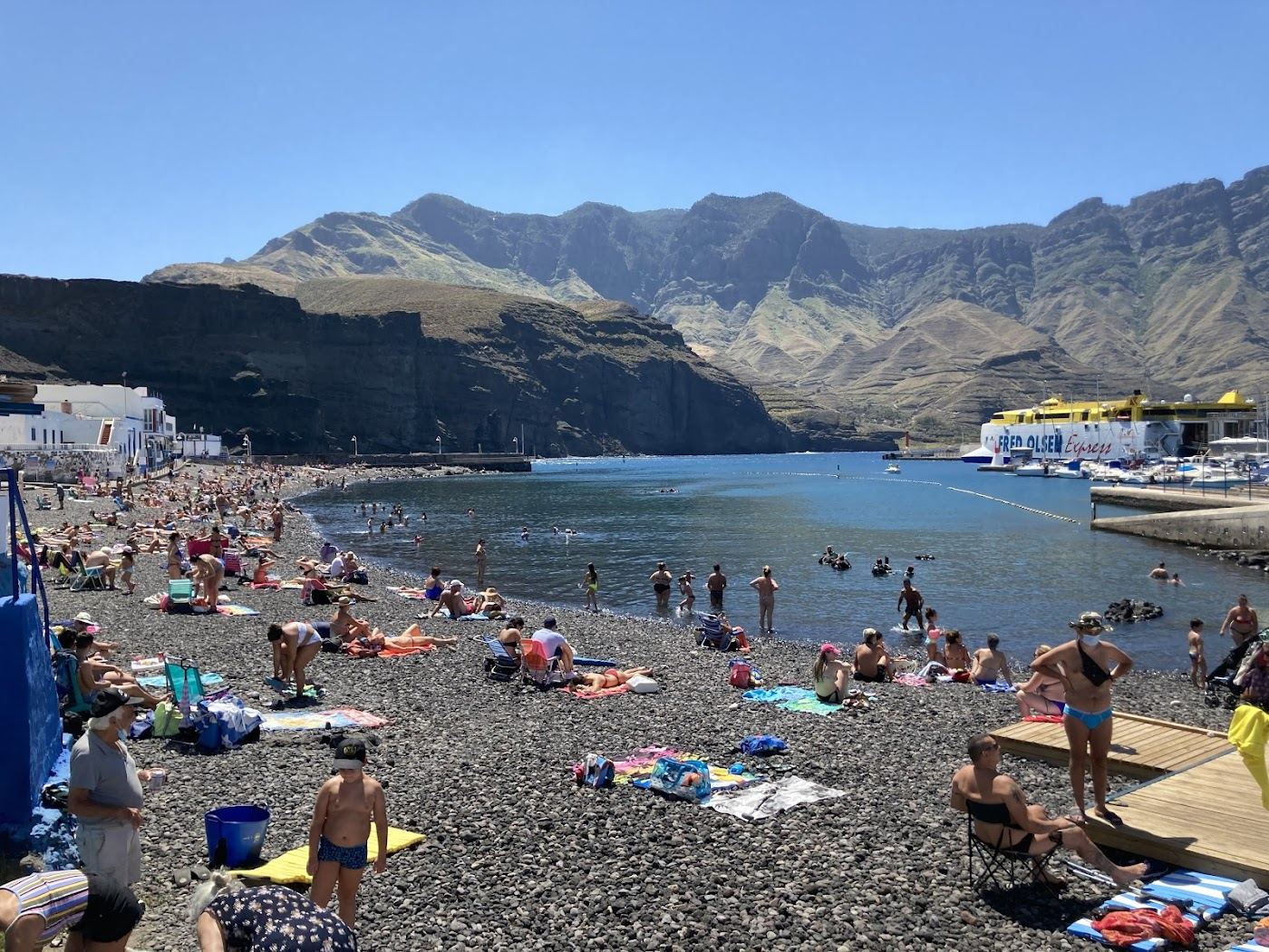 Dark pebble beach and fishing harbour at Puerto de las Nieves below the cliffs of Agaete in Gran Canaria