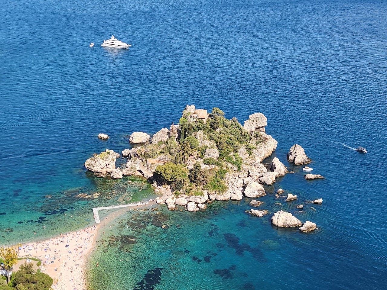 Isola Bella islet joined to the shore by its narrow causeway south of Mazzaro bay, Sicily