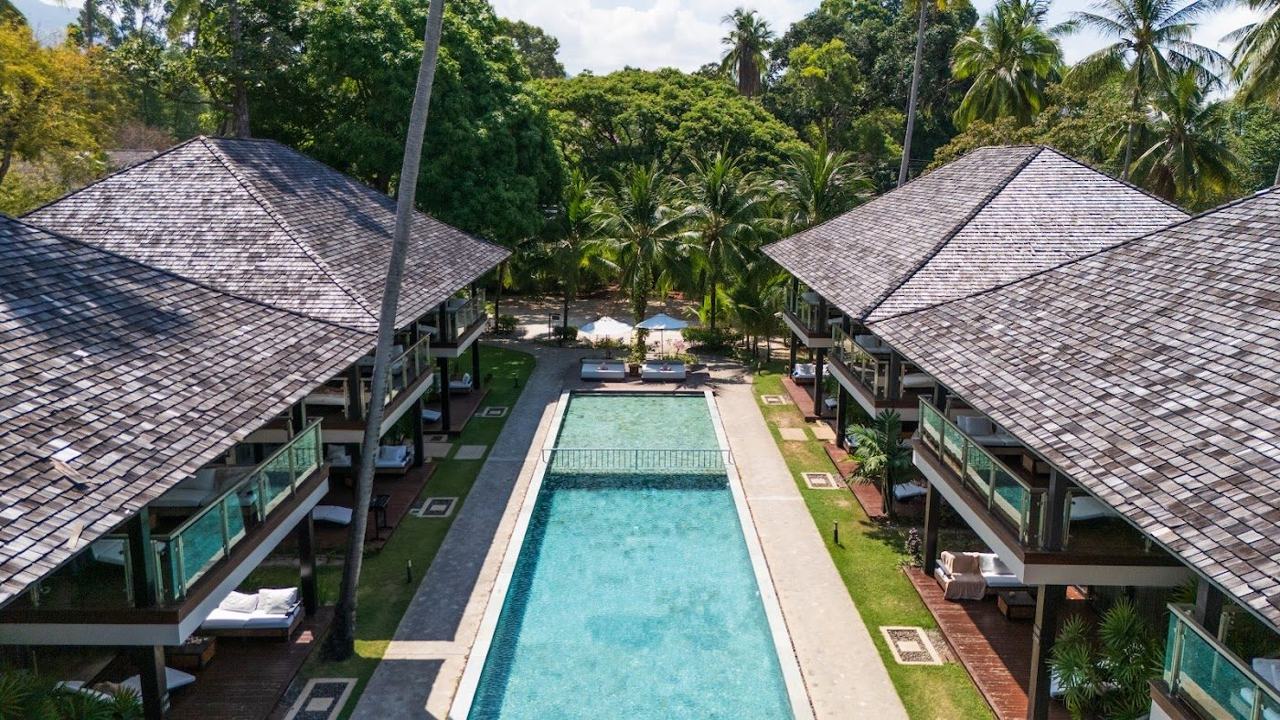 Pool, white daybeds and the sea at Nikki Beach Koh Samui on Lipa Noi Beach