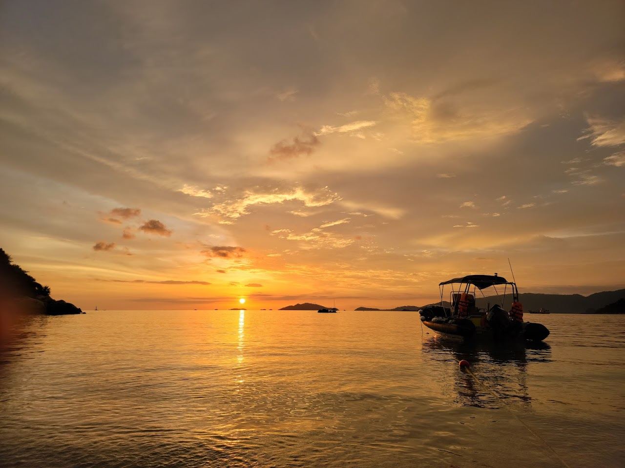 Quiet west facing sand and clear water looking toward Koh Adang at Sunset Beach on Koh Lipe