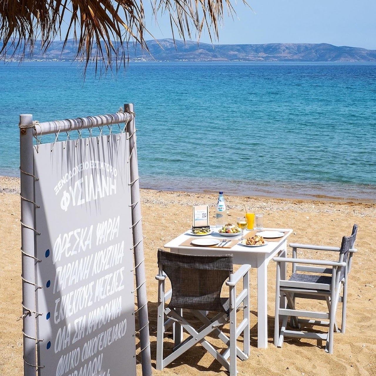 The soft sand and calm shallow water of Logaras bay beside Piso Livadi on the east coast of Paros