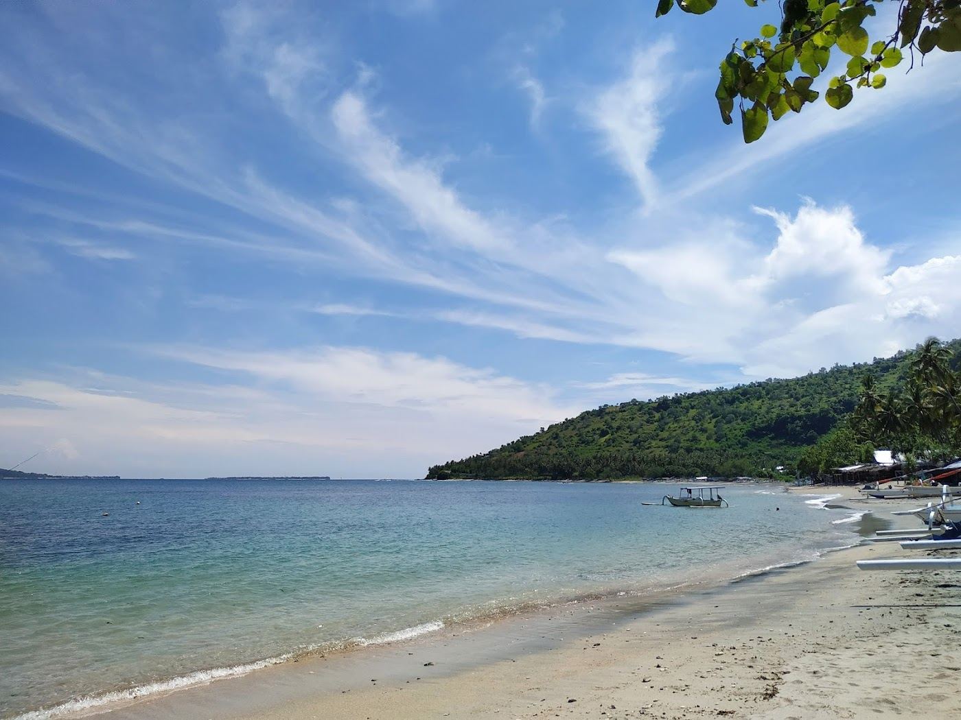 The quiet curved bay and calm water at Nipah Beach in north Lombok