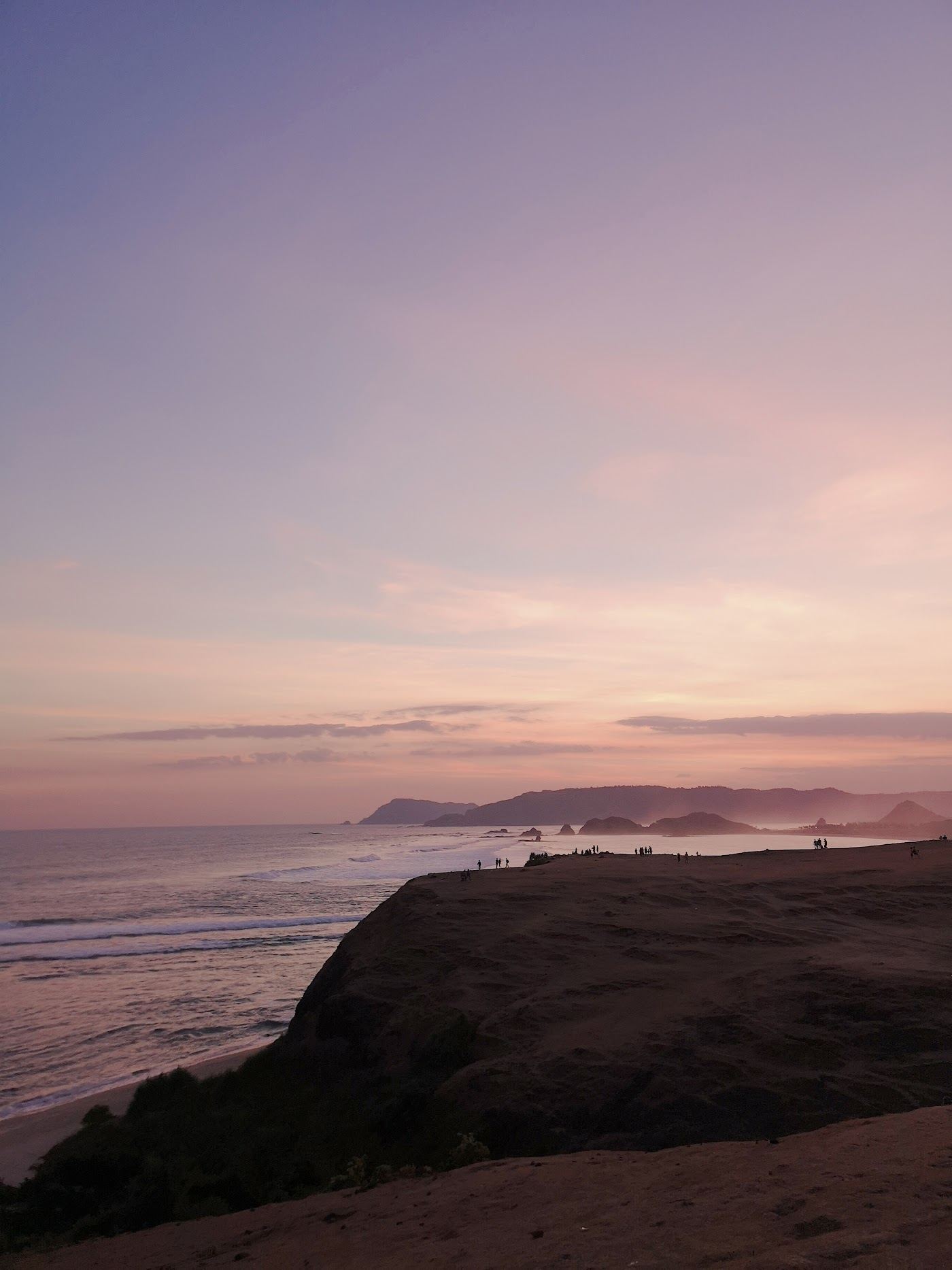 Soft evening light over a quiet bay and coastline on Lombok