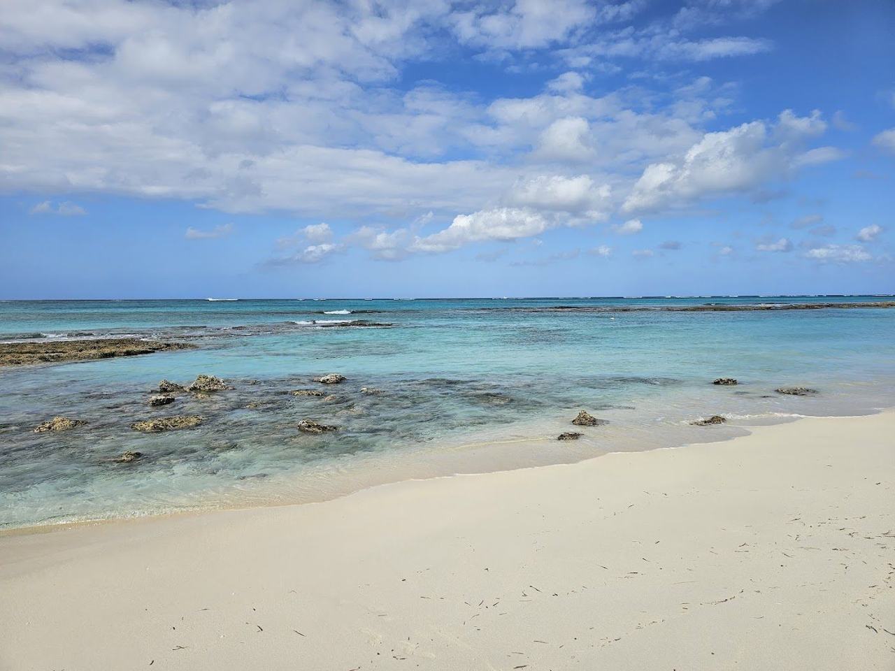Quiet pale sand and clear turquoise water at Love Beach on the west side of New Providence near Nassau Bahamas