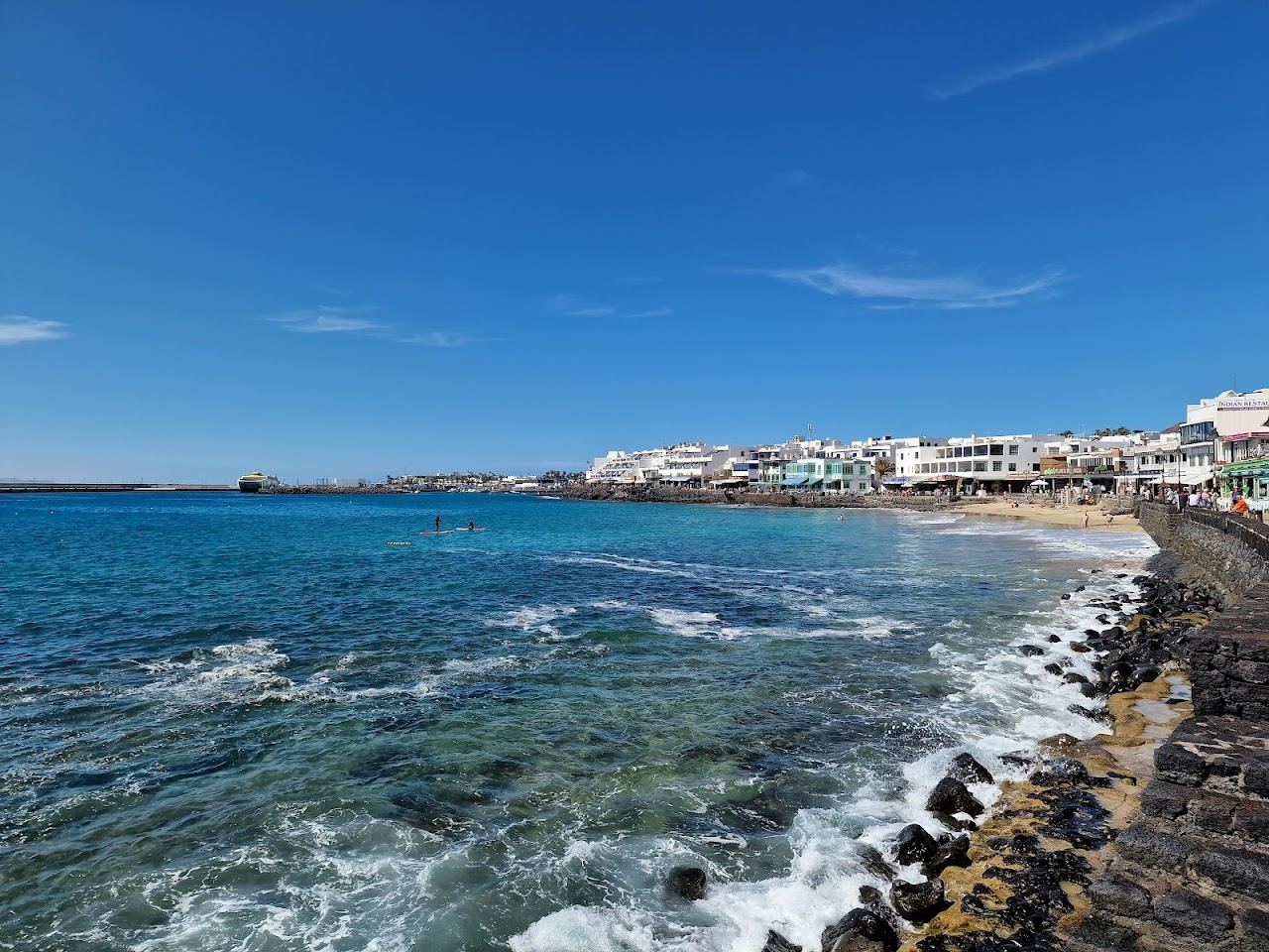 Calm town beach and seafront promenade at Playa Blanca in southern Lanzarote