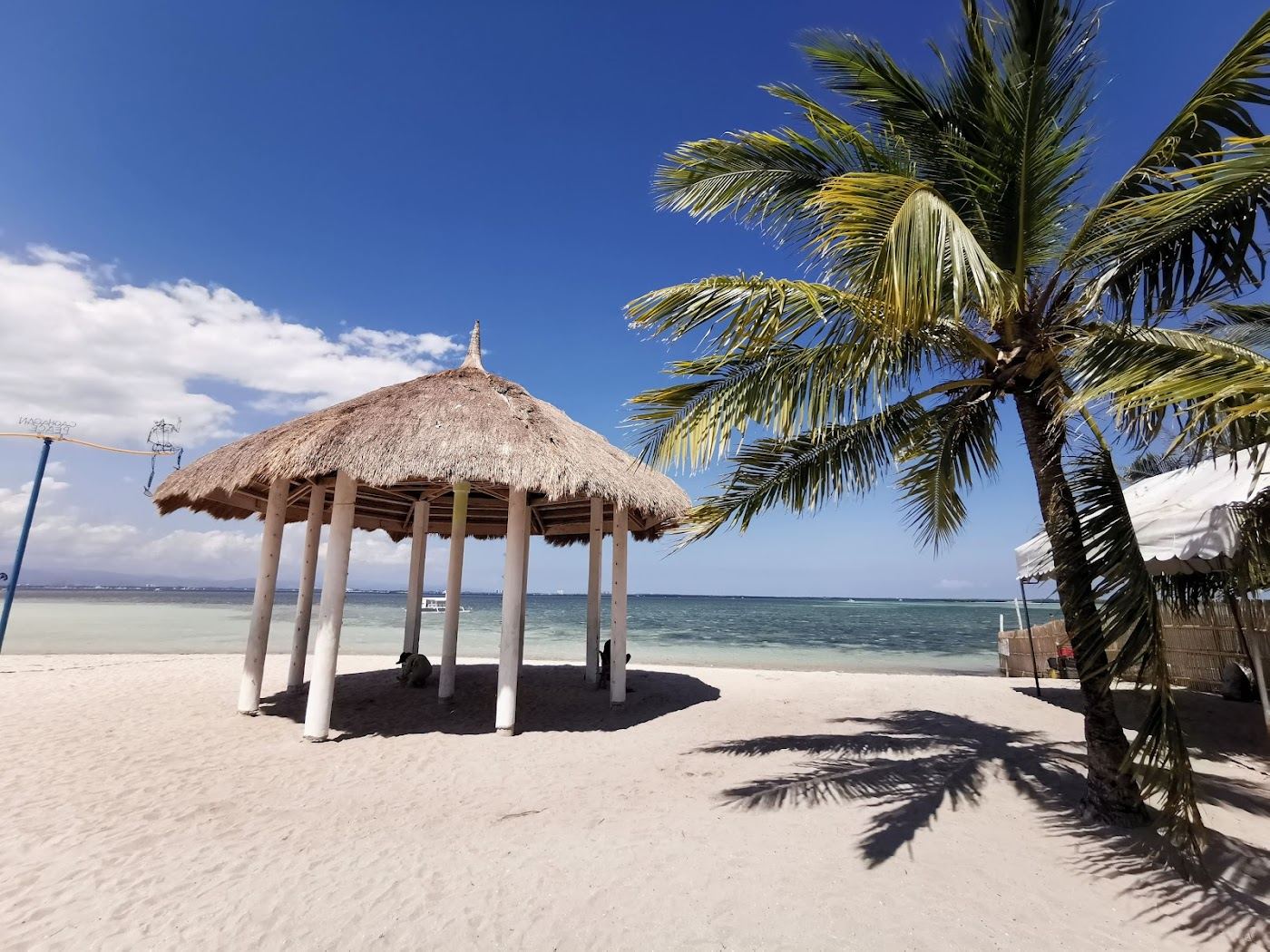 Quiet stretch of sand and clear shallow water on a small island off Mactan in Cebu Philippines