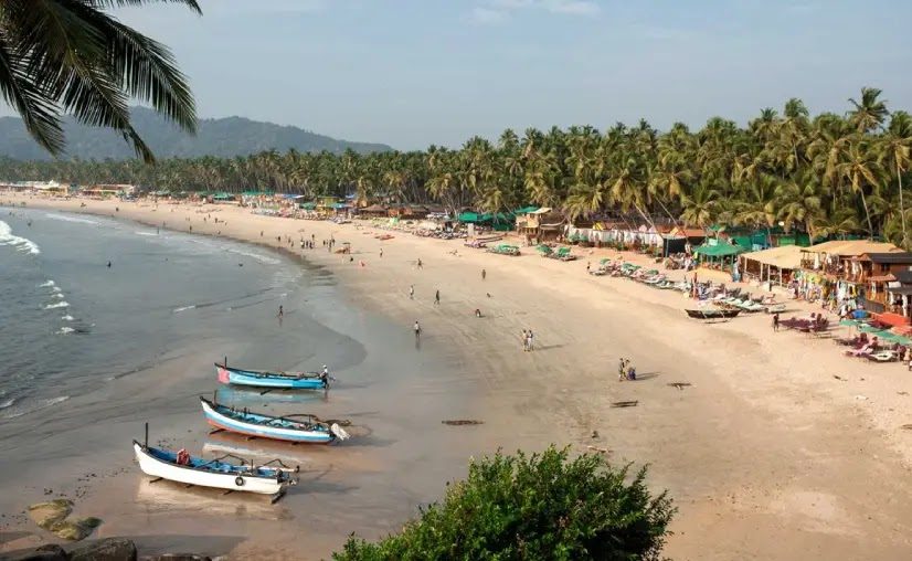 Majorda Beach long quiet white sand backed by a fringe of coconut palms in South Goa
