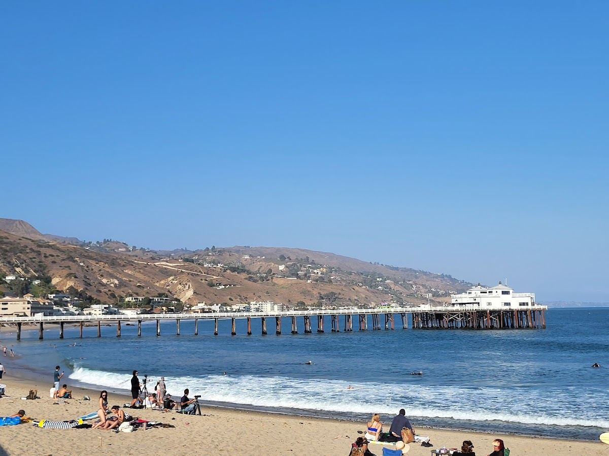 Surfers on the point break at Surfrider Beach beside Malibu Pier