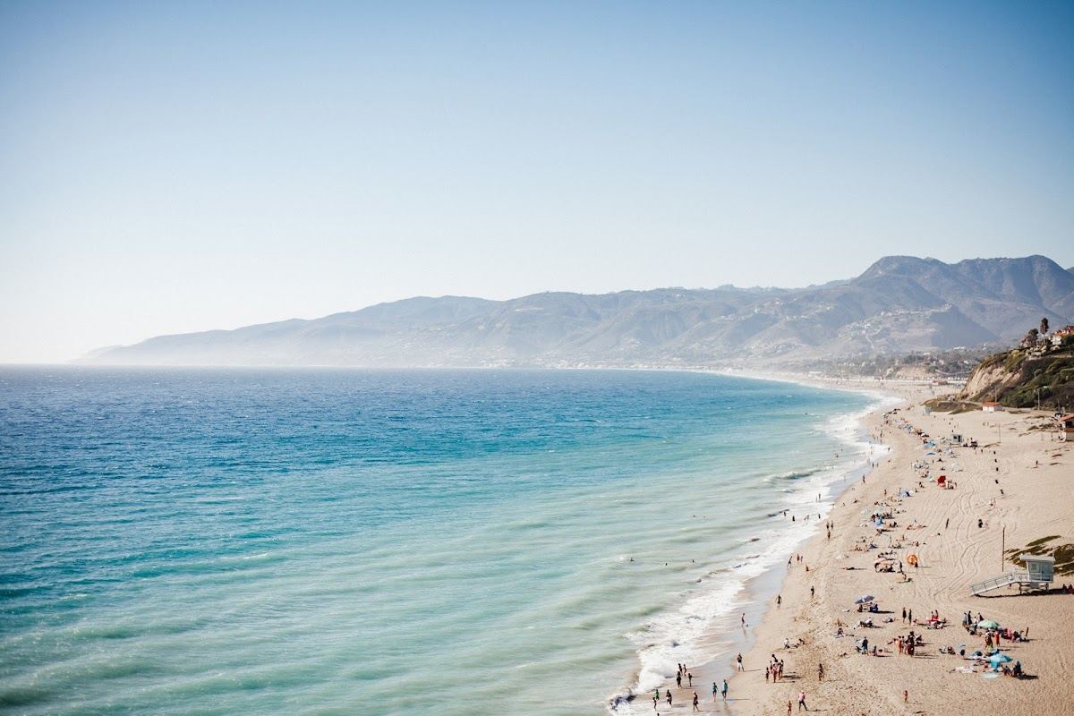 Golden afternoon light over the surf and bluffs of the Malibu coast
