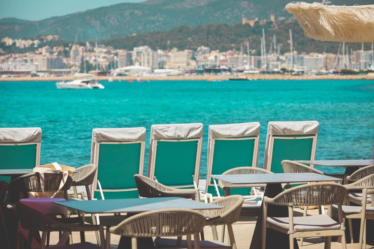 Stylish sunbeds and sea views at a beach club on the Bay of Palma in Mallorca
