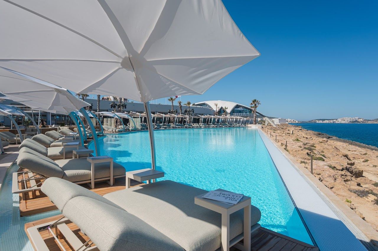 Sunbeds around an infinity pool above the sea at Cafe del Mar in St Paul's Bay, Malta