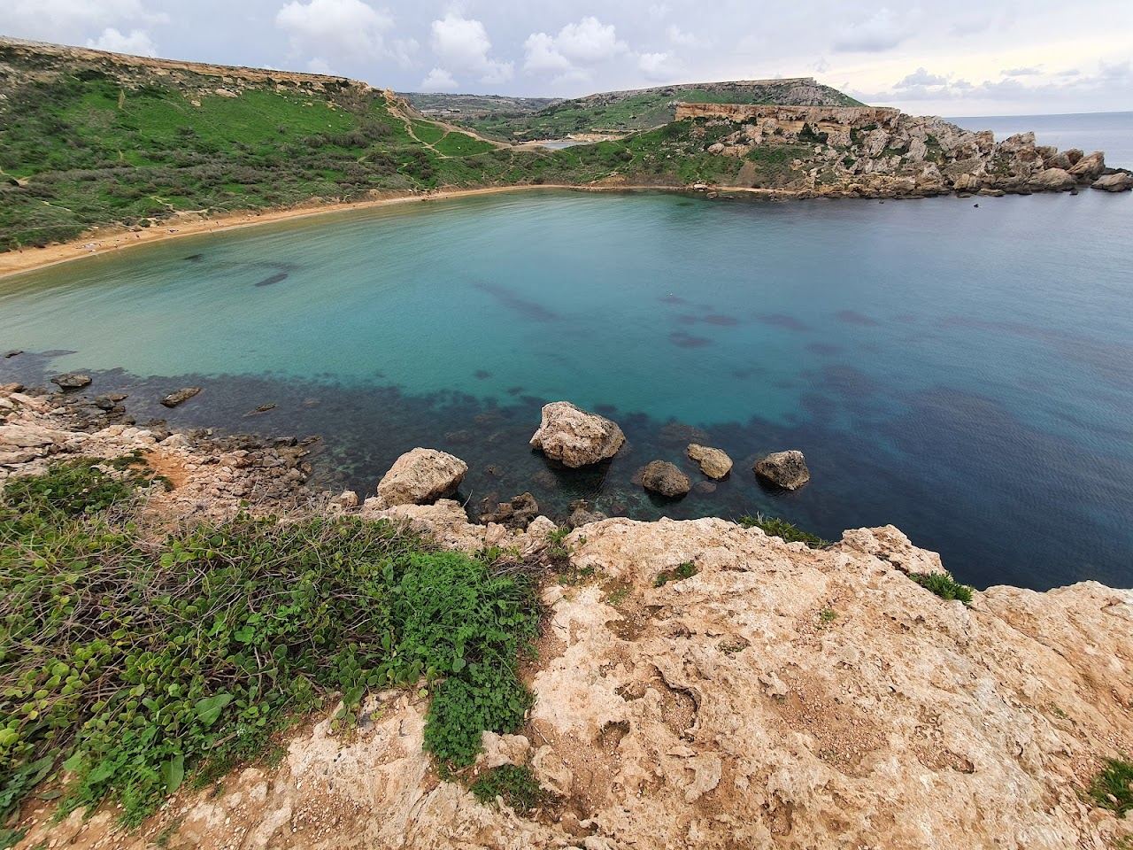 A scenic red gold bay at golden hour on the coast of Malta