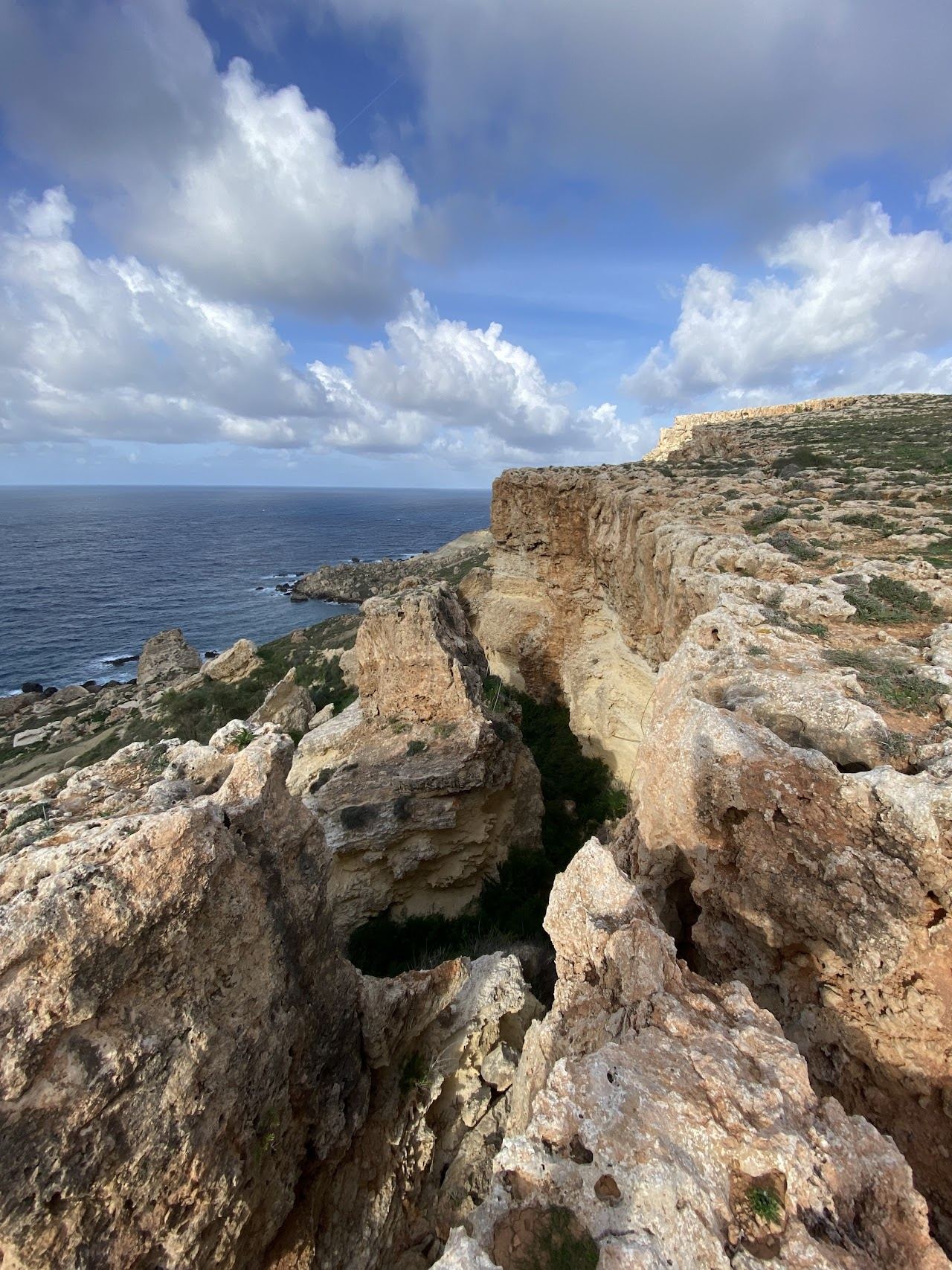 A wild secluded cliff framed bay on the coast of Malta