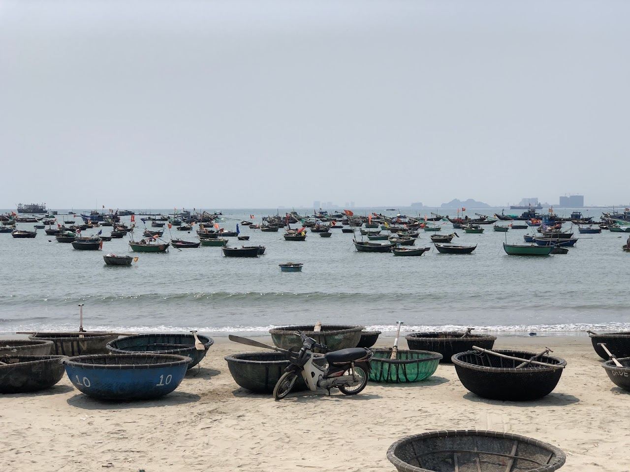 Calm water and fishing boats at Man Thai Beach below Son Tra in Da Nang, Vietnam