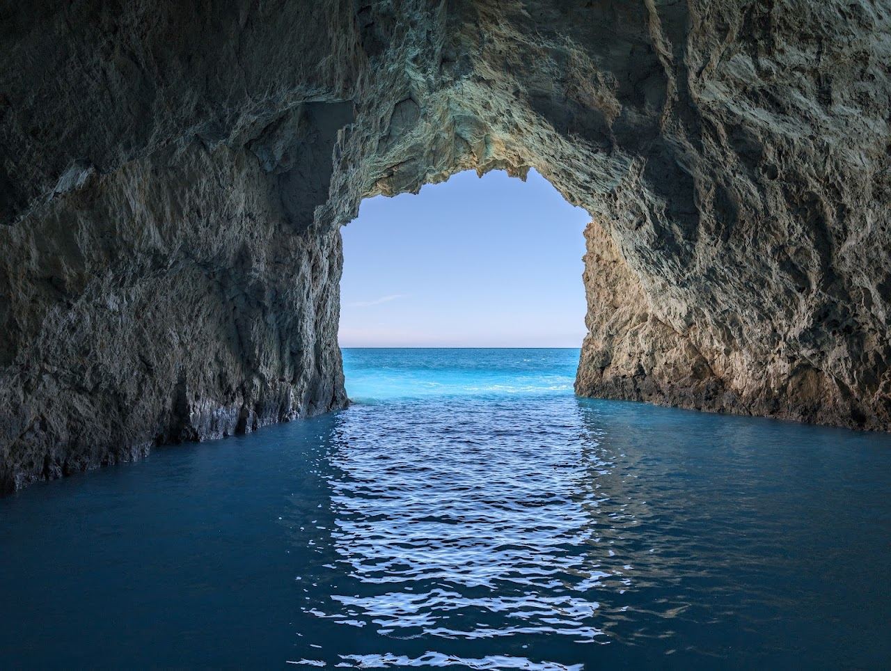 The uninhabited Marathonisi turtle island with pale sand and clear turquoise water in the marine park bay of Zakynthos