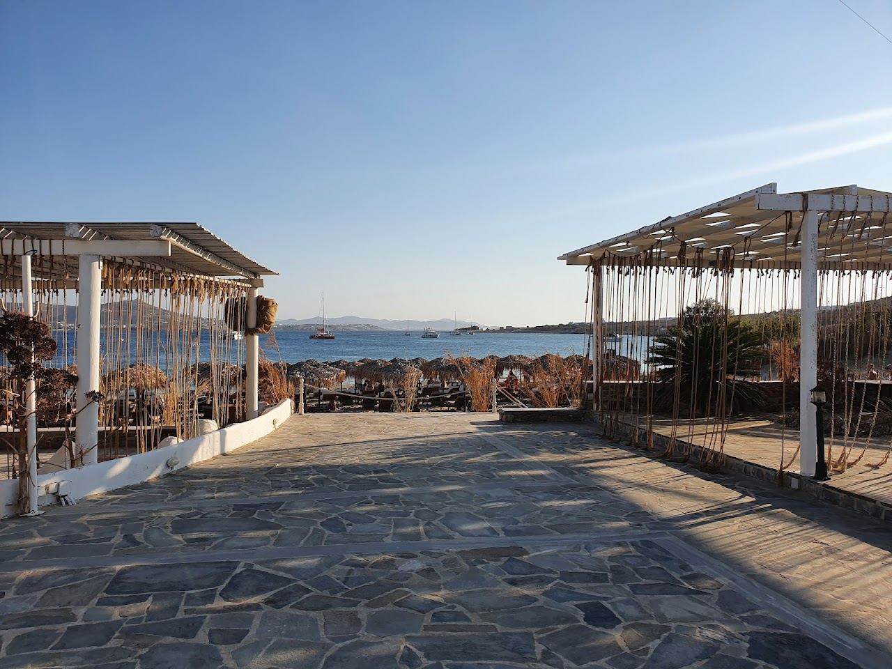 The pale sand and shallow clear water of Marcello beach seen along the north side of Parikia bay on Paros