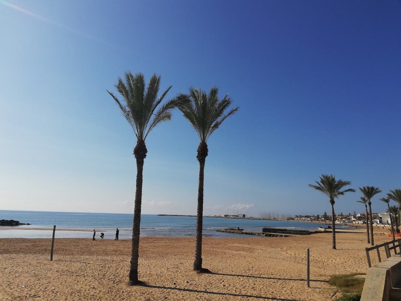Long sandy resort beach and marina at Marina di Ragusa on the southern coast of Sicily