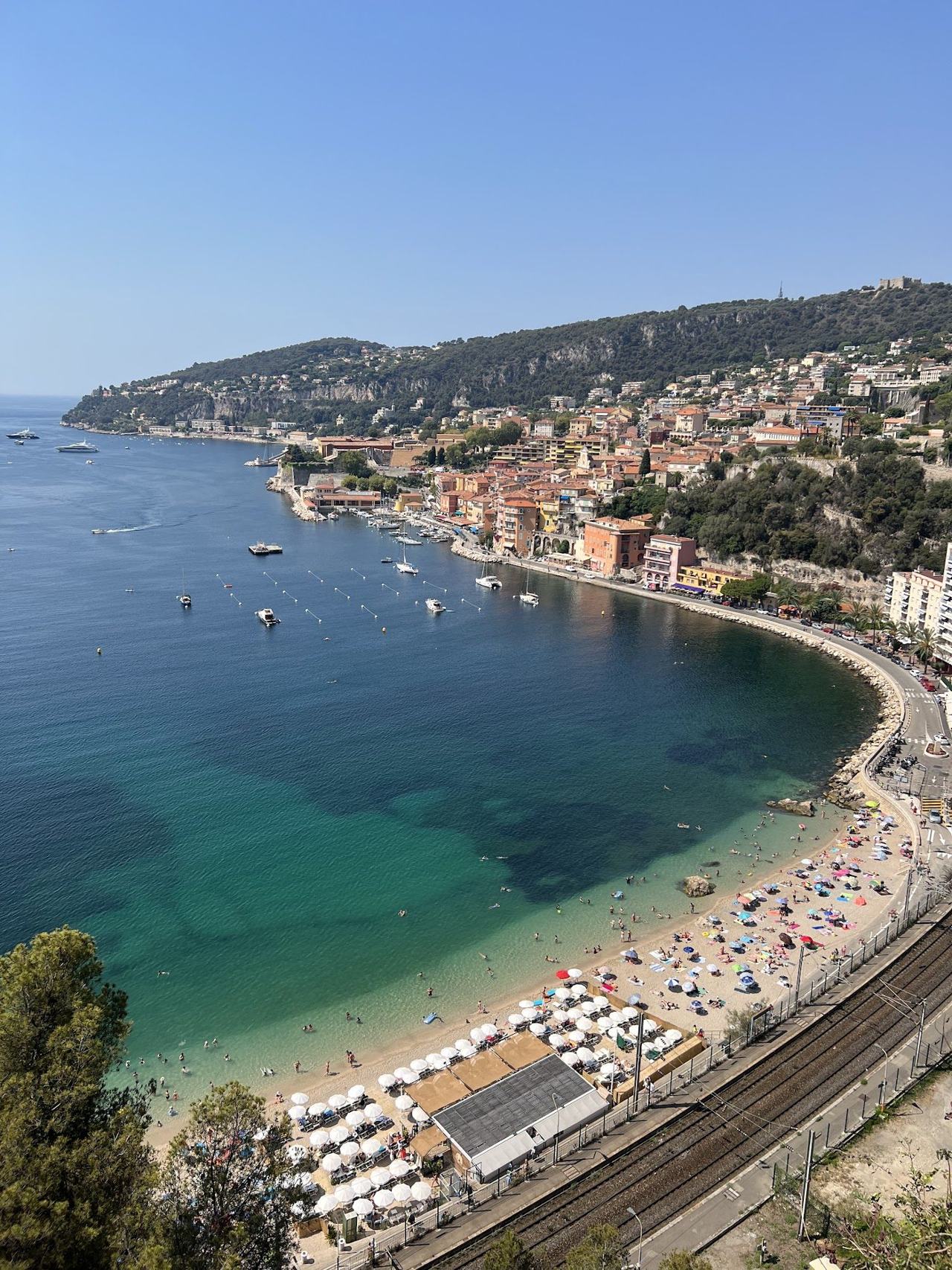 Soft sand and calm sheltered water at Plage des Marinieres in Villefranche sur Mer