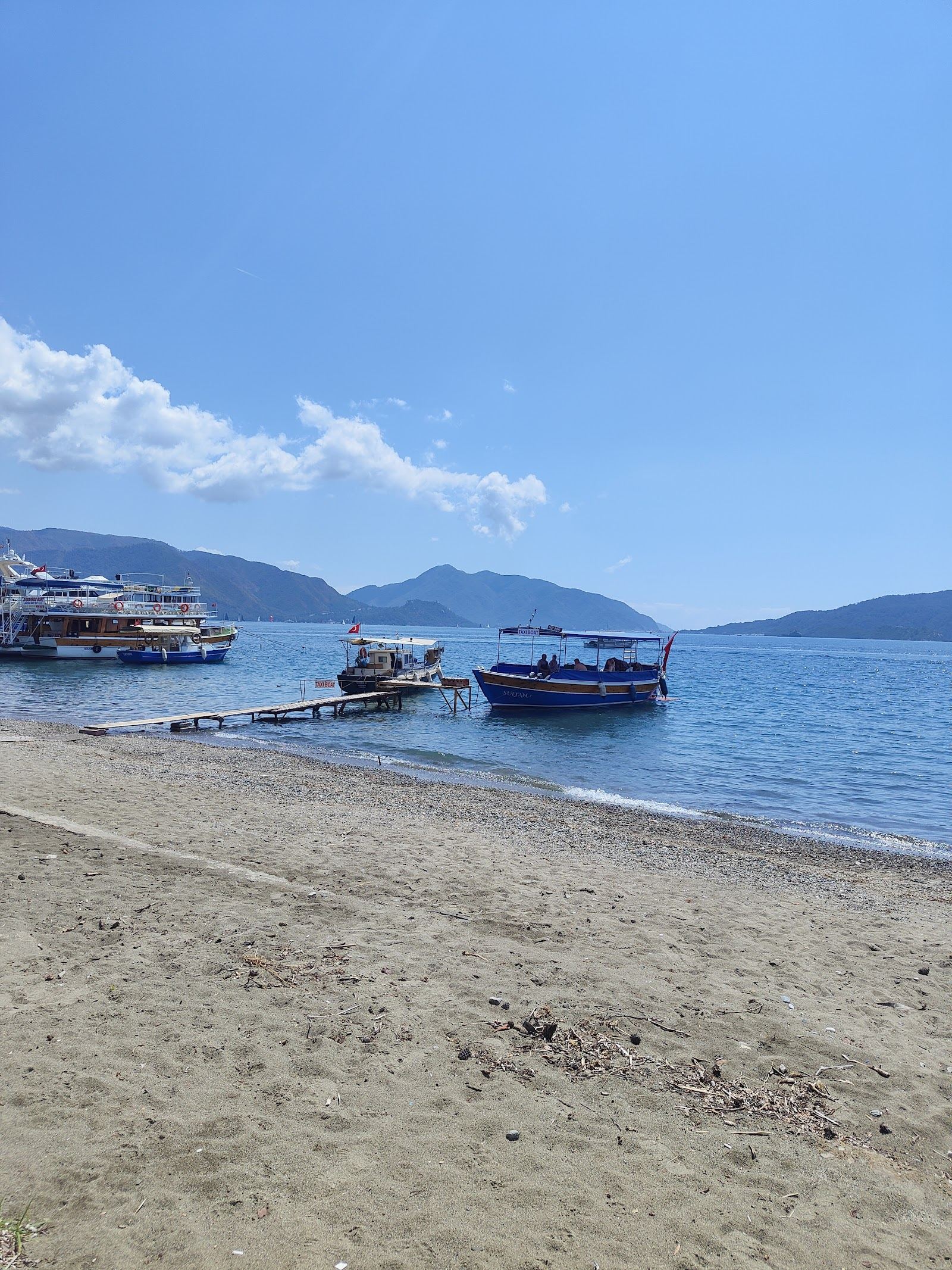 Long Beach Uzunyali running northeast of Marmaris town backed by the seafront promenade and hotels in Turkey