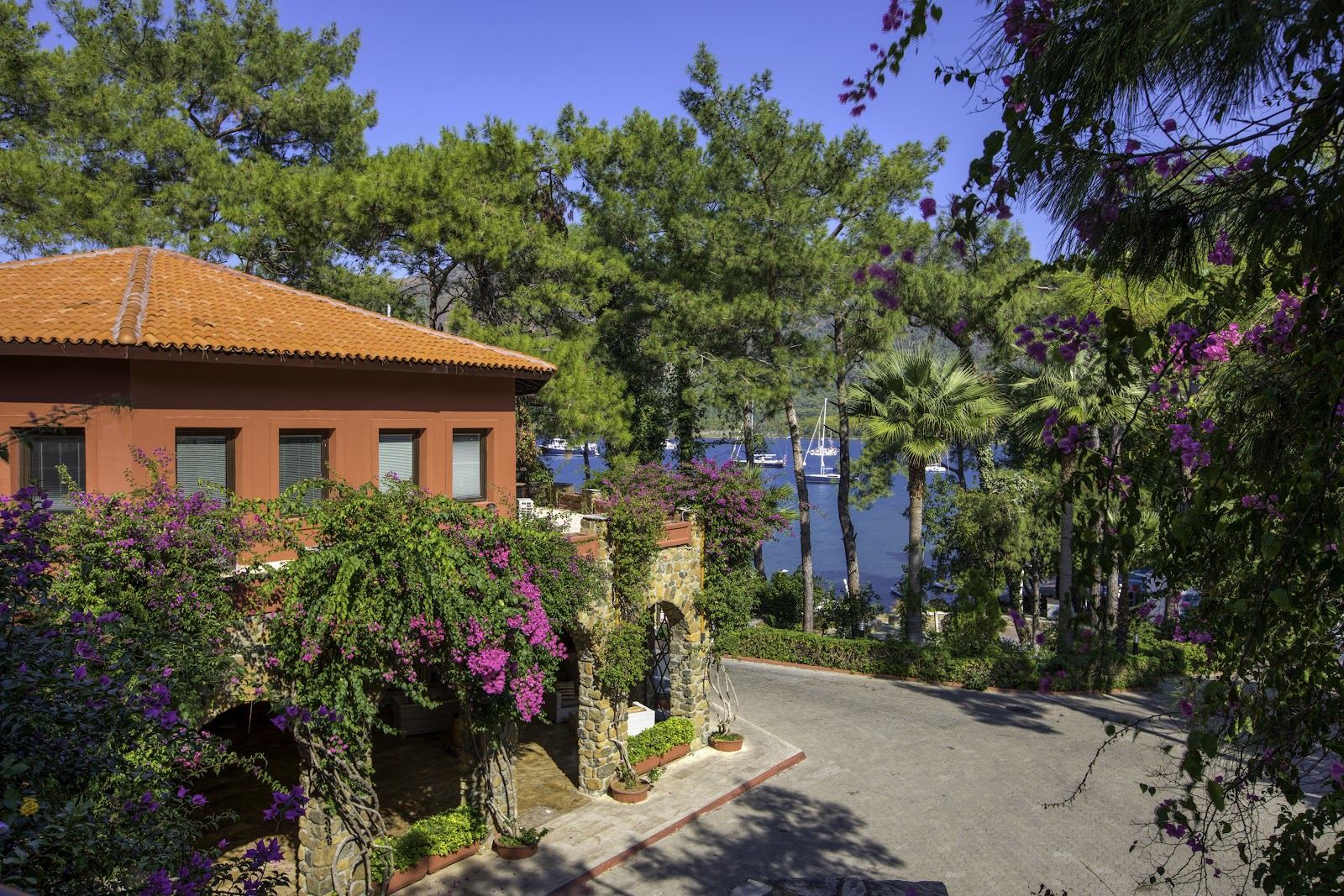 Marmaris bay ringed by pine covered hills with calm water and a resort shoreline in Turkey