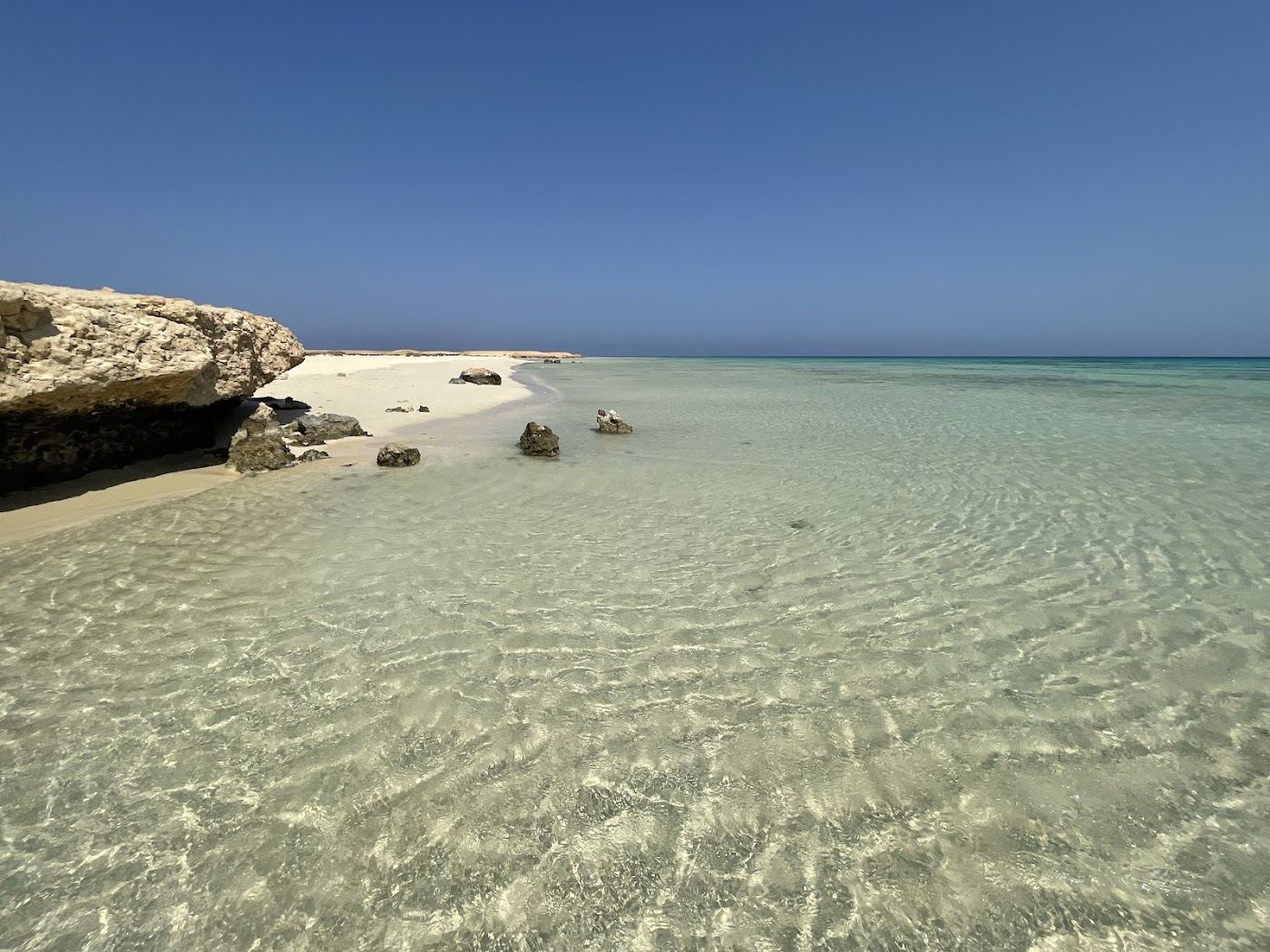 A wild empty white sand crescent and turquoise lagoon on the remote southern Marsa Alam coast