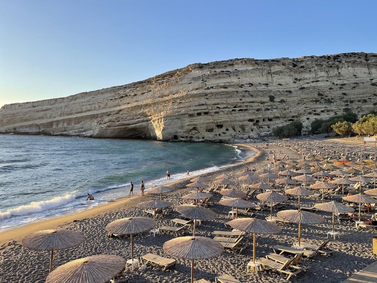 Sandy bay and carved cliff at Matala in southern Crete
