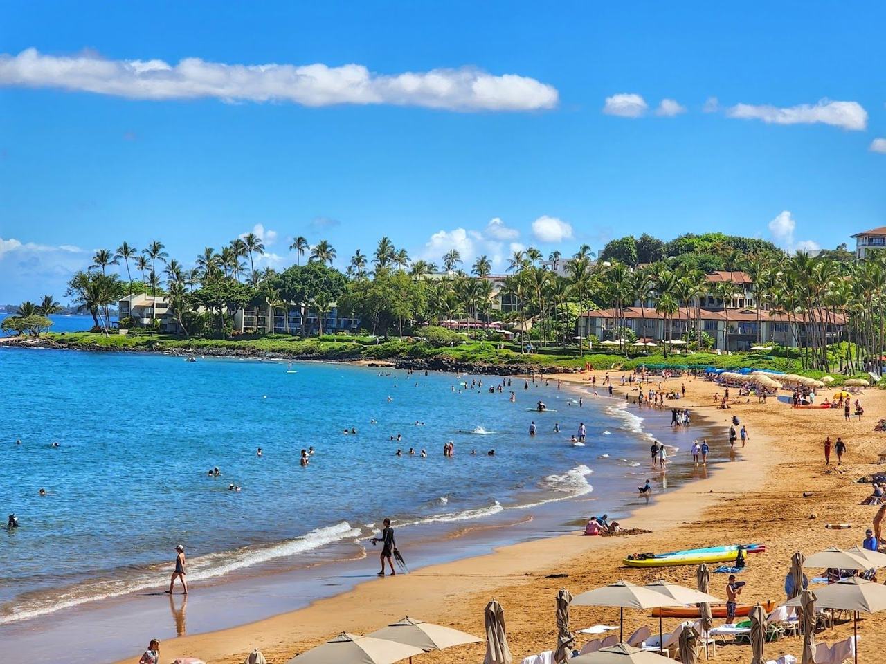 Golden sand and calm water at sunset along a resort beach on the south coast of Maui Hawaii