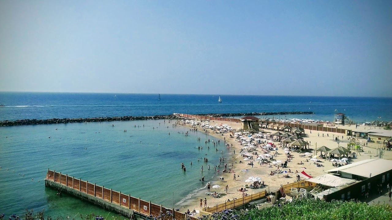 The sheltered cove, sunbeds and cafe terrace of Metzitzim beach in north Tel Aviv