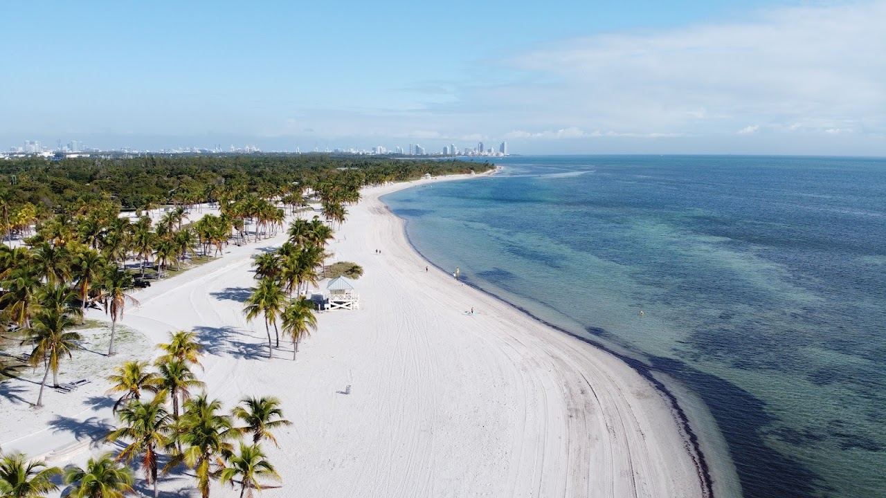Soft pale sand and calm shallow water on a Key Biscayne barrier island shore near Miami