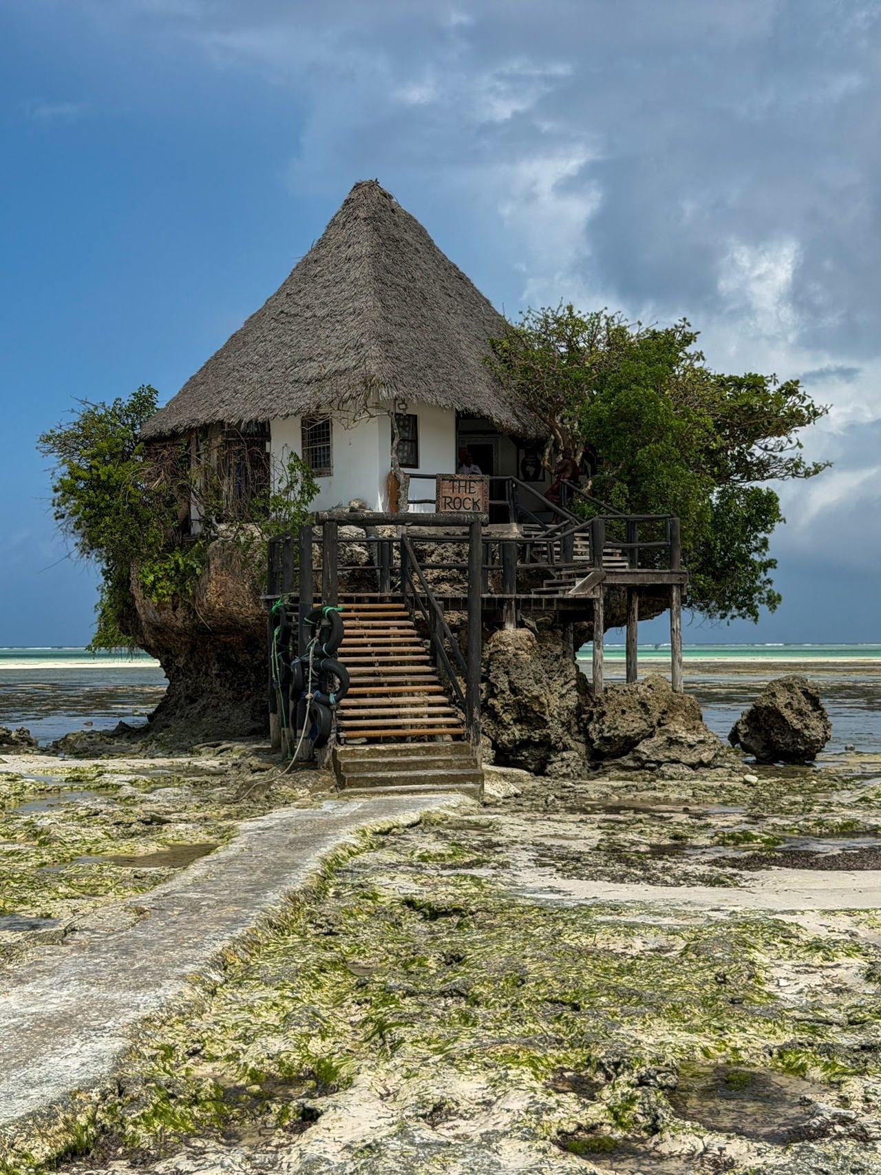 Pale white sand, palms and clear turquoise water along the quiet peninsula shore at Michamvi at the top of the southeast coast of Zanzibar